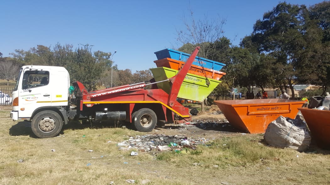 Waste Worx skip truck and containers at a collection site